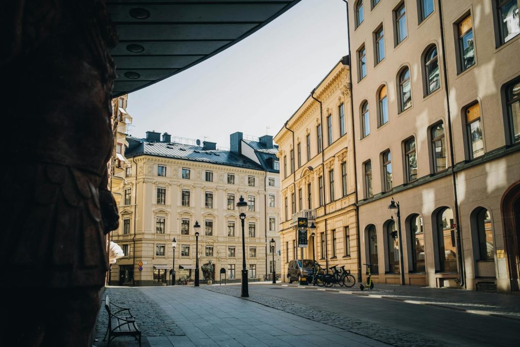 View of a quaint cobblestone street in Stockholm with neoclassical architecture and a tranquil urban ambiance.