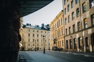 View of a quaint cobblestone street in Stockholm with neoclassical architecture and a tranquil urban ambiance.